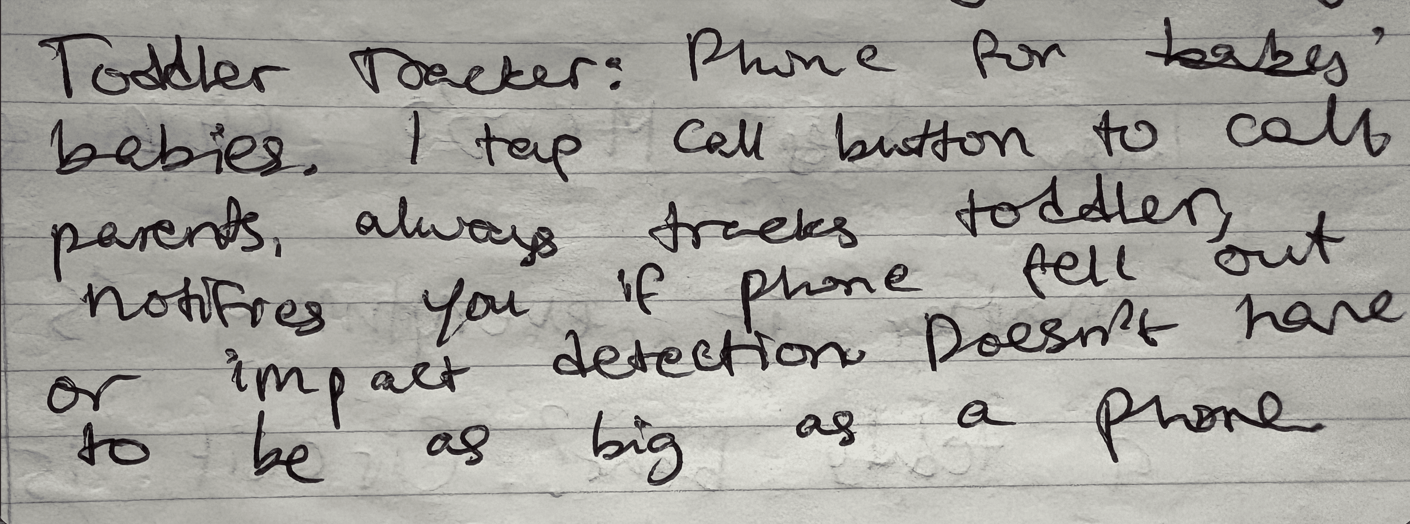 A handwritten notebook page reading: Toddler Tracker, phone for babies, 1 tap call button to call parents, always tracks toddler, notifies you if phone fell out or impact detection, doesn't have to be as big as a phone